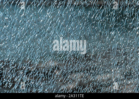 Closeup of a shattered glass pane in backlight Stock Photo