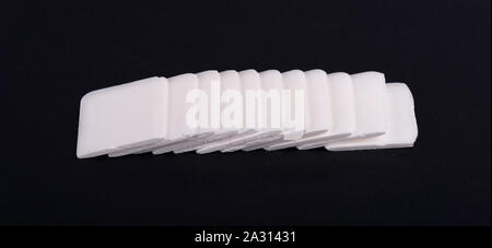 Tailor's chalk. White chalk for sewing on black background. Stock Photo
