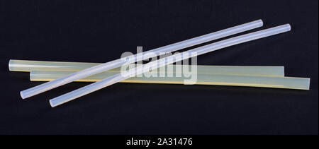 White hot glue sticks for handmade, isolated on black background. DIY. Stock Photo