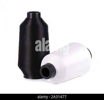 Sewing threads isolated on white background. White and black thread for tailoring sewing. Stock Photo