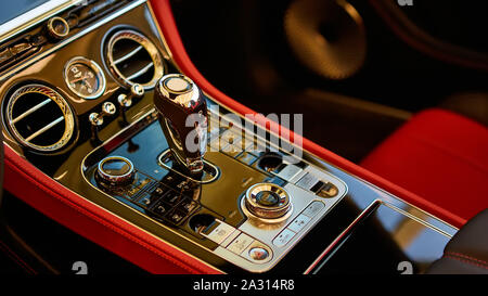 Automatic gear shift handle. Red luxury car Interior. Shallow doff. Stock Photo