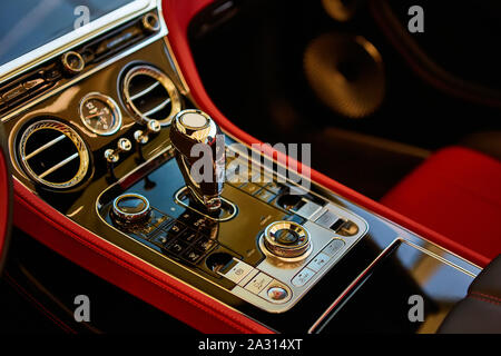 Automatic gear shift handle. Red luxury car Interior. Shallow doff. Stock Photo