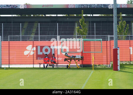 Mainz, Germany - September 22, 2019: Two paramedics sitting on the sidelines at a game of junior national league of the 1st FSV Mainz 05 on September Stock Photo