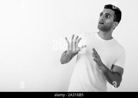 Young handsome Indian man against white background Stock Photo