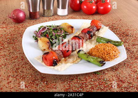 Meat  kebabs with fresh peppercorns and vegetables Stock Photo