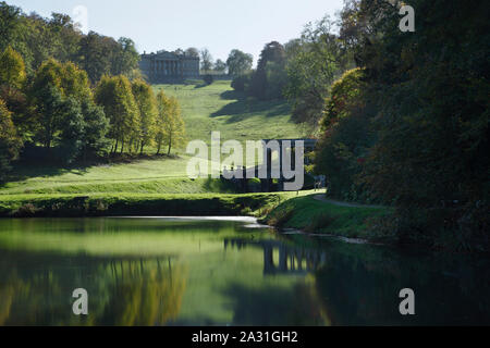Prior Park Landscape Garden. View of the Palladian Bridge and the house from the lower lake. Bath. UK.