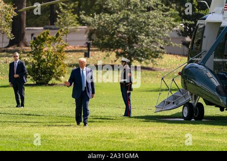 Washington, United States of America. 04 October, 2019. U.S President Donald Trump waves as he disembarks Marine One on the South Lawn of the White House October 4, 2019 in Washington, DC. Trump returned from a brief visit to Walter Reed National Military Medical Center where he visited wounded warriors.  Credit: Joyce Boghosian/White House Photo/Alamy Live News Stock Photo