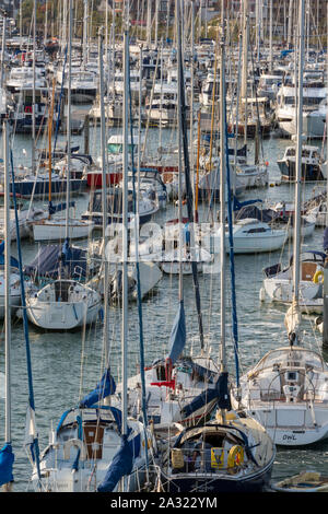 busy or crowded full marina with yachts and masts at lymington harbour new forest hampshire, england. Stock Photo