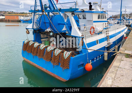 Rusty boat and nets for catching scallops Stock Photo