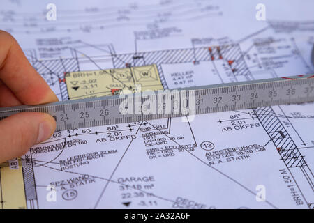 Hand of an architect measuring the extent on a planned house Stock Photo