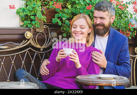 Married lovely couple relaxing together. Travel and vacation. Explore cafe and public places. Couple cuddling cafe terrace. Couple in love sit cafe terrace enjoy coffee. Pleasant family weekend. Stock Photo