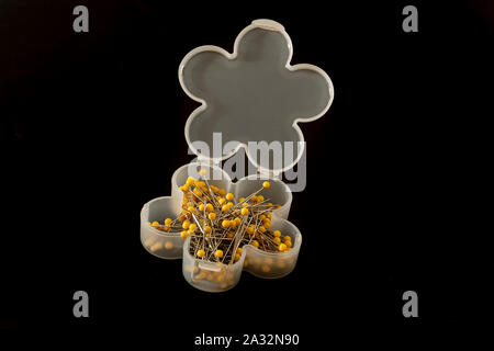 Tailor pins in a box on black background Stock Photo