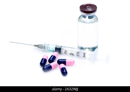 Syringe, capsules and vial on white background. Stock Photo