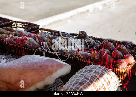 A traditional wooden salami slicer is seen close up on a market stall  during an agricultural and farming fair. Rustic butcher's tool for cutting  cured meats Stock Photo - Alamy