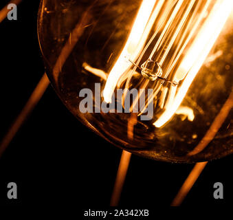Closeup of Retro Tungsten Light Bulb Isolated on Black Background Stock Photo