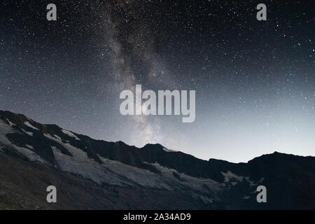 Milky Way and starry sky. Night landscape. Krimmler Kees glacier. High Krimmler Achen valley. Hohe Tauern Nationalpark. Austrian Alps. Europe. Stock Photo