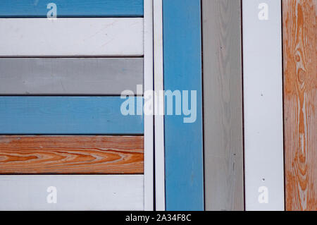 Decorative and colorful wood wall. White grey red and blue panels. Stock Photo