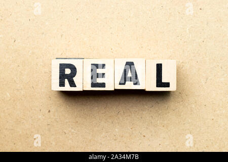 Letter block in word real on wood background Stock Photo