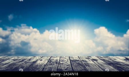 Empty wooden floor with blurred cloudy blue sky background. For product display. Stock Photo