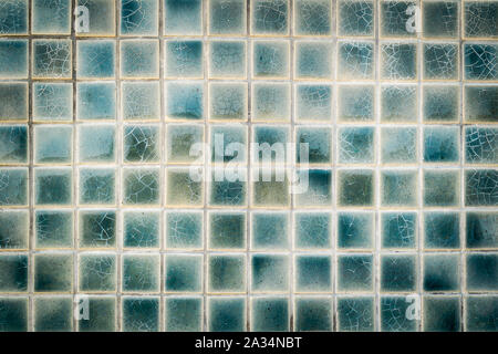 cracked and old wall mosaic tiles background Stock Photo