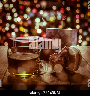 Hot tea with gift box on wooden table in colorful bokeh background Stock Photo