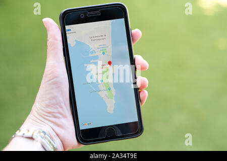Gibraltar 04 October 2019: A hand holding an iphone showing the google maps app and focusing on the region of Gibraltar Stock Photo
