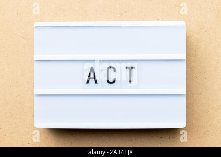 White lightbox with word act on wood background Stock Photo