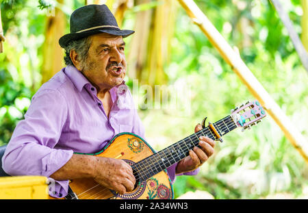 Indigenous men playing guitar in the village of Jardin - Colombia Stock Photo