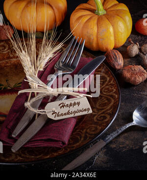 Autumn place setting and mini pumpkins on a rustic wooden table Stock Photo