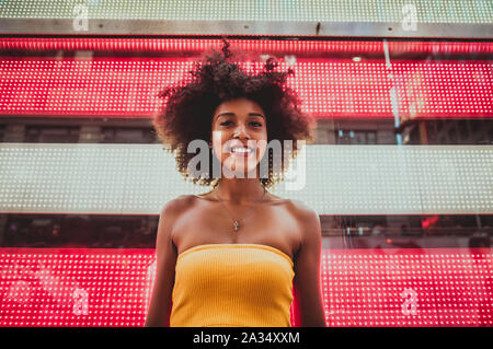 Young beautiful girl walking in Time square, manhattan. Lifestyle concepts about New york Stock Photo