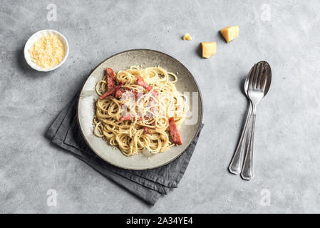 Carbonara pasta, spaghetti with bacon, egg, hard parmesan cheese and cream sauce. Traditional italian cuisine. Pasta alla carbonara, top view, copy sp Stock Photo