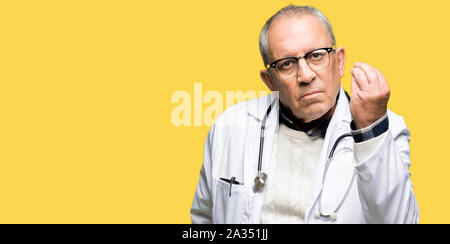 Handsome senior doctor man wearing medical coat Doing Italian gesture with hand and fingers confident expression Stock Photo