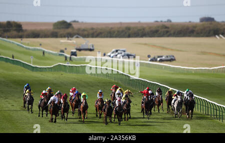 Runners and riders in the 150,000 Tattersalls October Auction Stakes at Newmarket Racecourse. Stock Photo