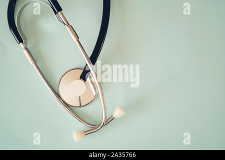 The black stethoscope on a turquoise background Stock Photo
