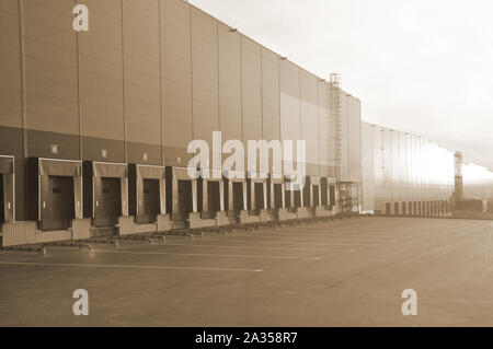 Modern warehouse complex. View of loading docks in the rays of the rising sun Stock Photo