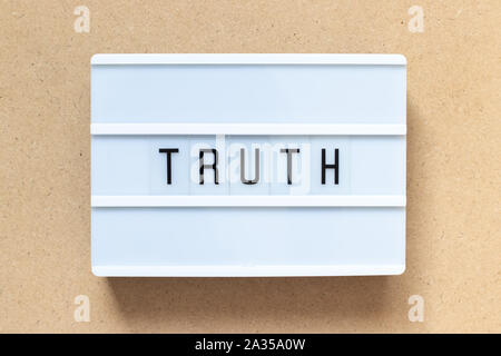 White lightbox with word truth on wood background Stock Photo