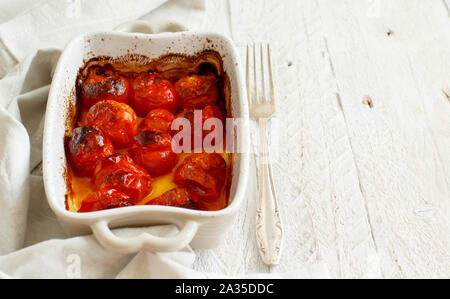 Roasted cherry tomatoes in a small casserole close up Stock Photo