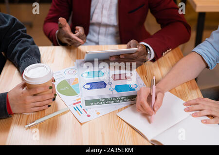 Contemporary young African businessman pointing at touchpad display Stock Photo