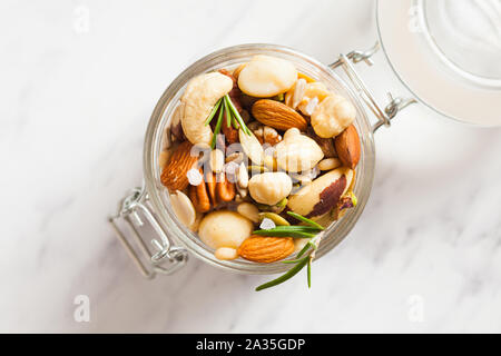 Mix of different types of nuts with salt and rosemary Stock Photo