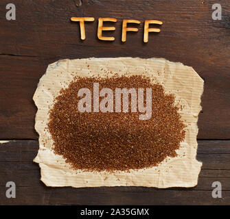 Pile of uncooked  teff grain with a spoon close up Stock Photo