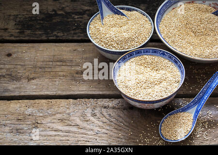 Quinoa in bowls on wooden table Stock Photo