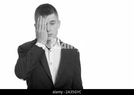 Studio shot of young businessman looking tired Stock Photo