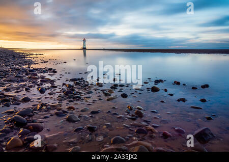 Point of Ayr Lighthouse on Talacre Beach at sunset Stock Photo