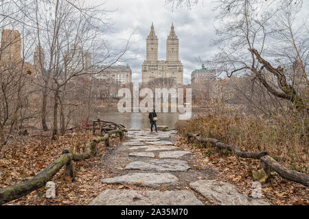 New York Central park day light view with couples  standing in a trail photographed from behind Stock Photo