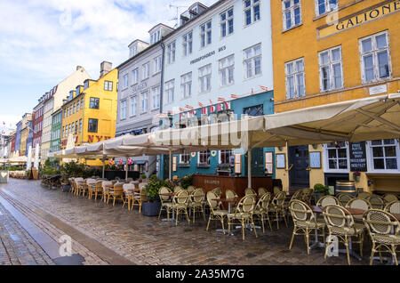 Copenhagen, Denmark - May 04, 2019: Colourful facades and restaurants on the Nyhavn embankment along the Nyhavn Canal in Copenhagen, Denmark Stock Photo