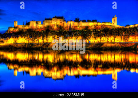 Chinon, France. Picturesque night view of the River Vienne at Chinon, with the floodlit Fortress Royal and Fort Saint George in the background.
