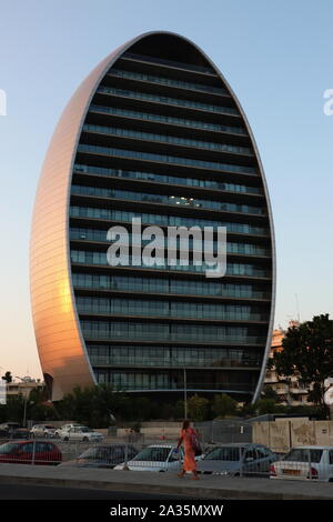 Distinctive oval shaped building at sunset Stock Photo