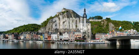 Dinant, Namur / Belgium - 11 August 2019: panorama view of the small town of Dinant on the Maas river with the historic citadel and cathedral on the r