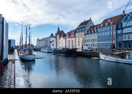 Copenhagen, Denmark - May 04, 2019: Colourful facades and restaurants on Nyhavn embankment and old ships along the Nyhavn Canal in Copenhagen, Denmark Stock Photo