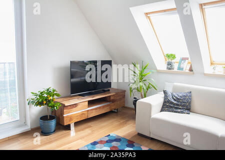 loft living room with wooden tv stand and white sofa Stock Photo